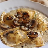 Ravioli stuffed with pumpkin, covered in a creamy sauce, and topped with sautéed mushrooms.